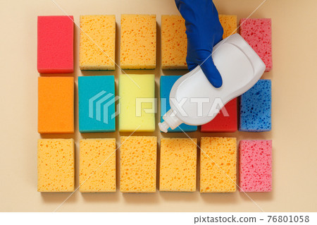 Sponges of different colors on a beige background. Sponges of different colors on a beige background. 76801058