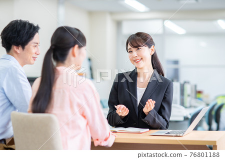 Young couple consulting a consultant Young couple consulting a consultant 76801188