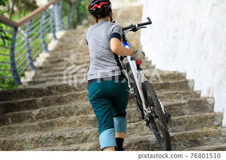 Successful woman looking at the view on high altitude mountain top 76801510