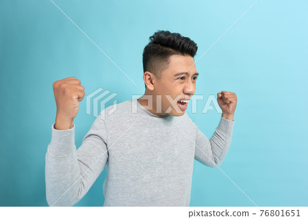 Excited businessman celebrating a win 76801651