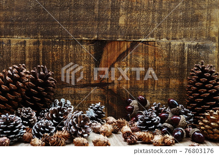 Christmas Festive background concept decoration with pine cones on wooden background 76803176