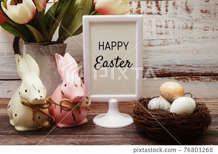 Happy Easter with flower, rabbit and easter eggs decoration on wooden background Happy Easter with flower, rabbit and easter eggs decoration on wooden background 76803268