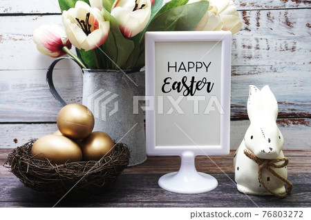 Happy Easter with flower, rabbit and easter eggs decoration on wooden background Happy Easter with flower, rabbit and easter eggs decoration on wooden background 76803272