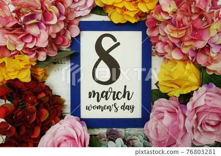 8 March Womans Day Card with colorful flowers border frame on wooden background 8 March Womans Day Card with colorful flowers border frame on wooden background 76803281