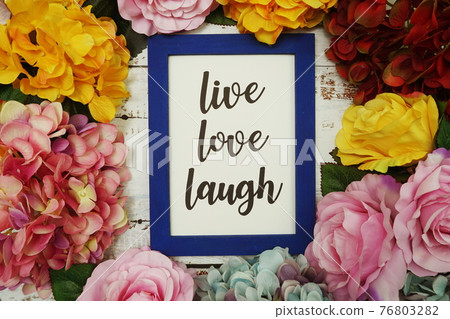 Live Love Laugh Card with colorful flowers border frame on wooden background Live Love Laugh Card with colorful flowers border frame on wooden background 76803282