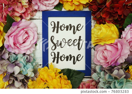 Home Sweet Home Card with colorful flowers border frame on wooden background Home Sweet Home Card with colorful flowers border frame on wooden background 76803283