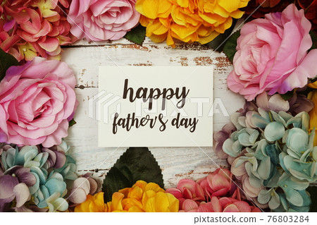Happy Fathers day Card with colorful flowers border frame on wooden background 76803284