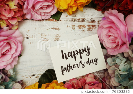 Happy Fathers day Card with colorful flowers border frame on wooden background 76803285