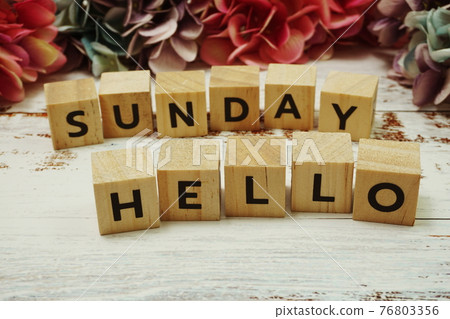 Hello Sunday alphabet letter on wooden background Hello Sunday alphabet letter on wooden background 76803356