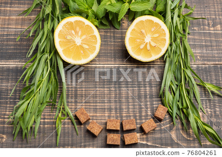 the concept of a summer drink, of the ingredients of lemonade lined face on wooden boards, lemon and mint, tarragon and brown sugar, rustic style the concept of a summer drink, of the ingredients of lemonade lined face on wooden boards, lemon and mint, tarragon and brown sugar, rustic style 76804261