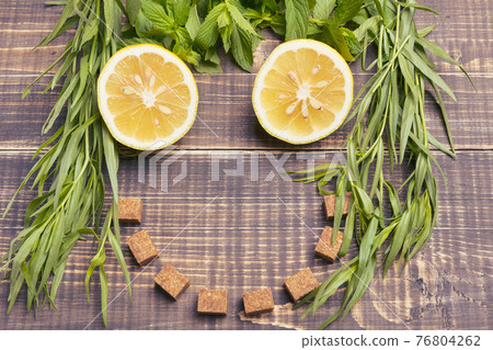 the concept of a summer drink, of the ingredients of lemonade lined face on wooden boards, lemon and mint, tarragon and brown sugar, rustic style the concept of a summer drink, of the ingredients of lemonade lined face on wooden boards, lemon and mint, tarragon and brown sugar, rustic style 76804262