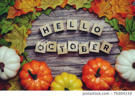 Hello October alphabet letter with pumpkin and maple leaves decoration on wooden background Hello October alphabet letter with pumpkin and maple leaves decoration on wooden background 76804338