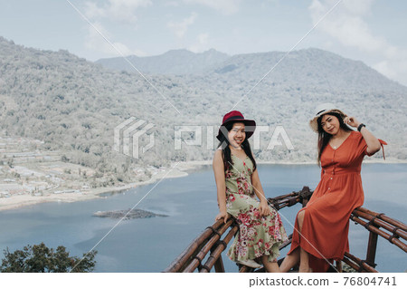 Young pretty Asian women feeling relax with ocean and mountain view in Wanagiri, Bali. Tourist concept. 76804741