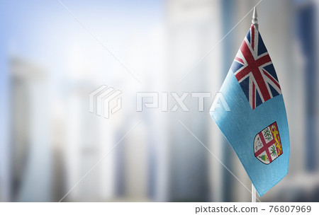 A small flag of Fiji on the background of a blurred background A small flag of Fiji on the background of a blurred background 76807969