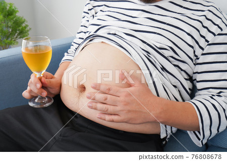An obese man who drinks too much alcohol An obese man who drinks too much alcohol 76808678