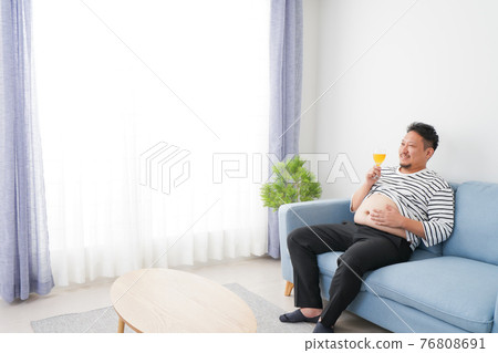 An obese man who drinks too much alcohol An obese man who drinks too much alcohol 76808691