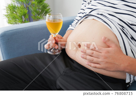 An obese man who drinks too much alcohol An obese man who drinks too much alcohol 76808715