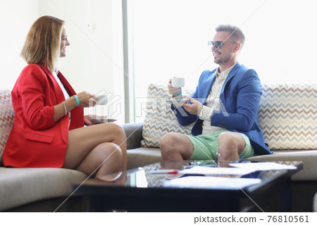 Young man and woman drinking coffee in office Young man and woman drinking coffee in office 76810561