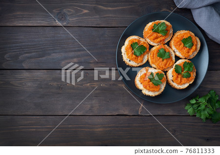 Sandwiches with bread zucchini caviar tomatoes onions. Homemade vegetarian food. Canned stewed vegetable. wooden background top view, copy space Sandwiches with bread zucchini caviar tomatoes onions. Homemade vegetarian food. Canned stewed vegetable. wooden background top view, copy space 76811333
