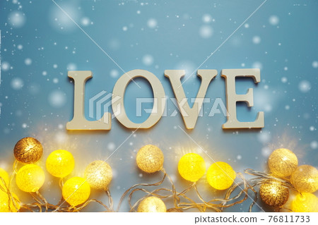 LOVE alphabet letter with LED cotton balls on blue background LOVE alphabet letter with LED cotton balls on blue background 76811733