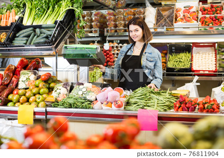 Happy woman seller displaying assortment Happy woman seller displaying assortment 76811904