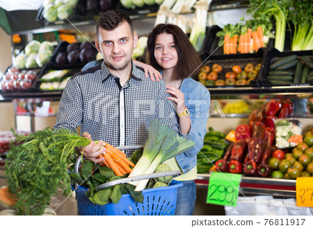 Couple choosing vegetables Couple choosing vegetables 76811917