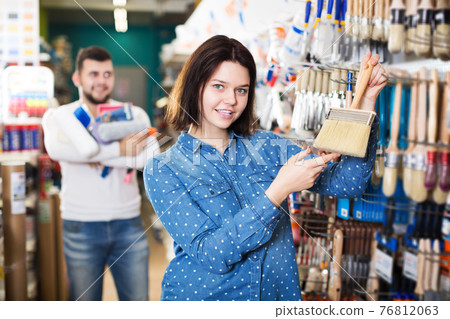 Couple choosing brush for house decoration Couple choosing brush for house decoration 76812063