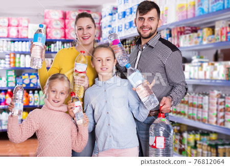 family holding bottled mineral water 76812064