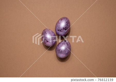 Glitter Easter eggs in pink purple colors on beige background. Easter holiday creative concept background with dark shadows 76812139
