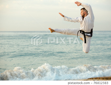 Nice male practising karate kata poses 76812383