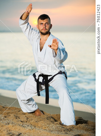 Guy doing karate poses Guy doing karate poses 76812423