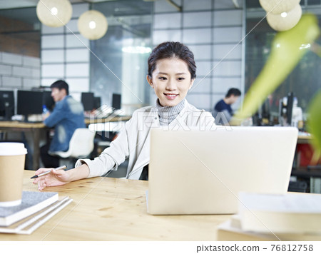 young asian business woman working in office using laptop computer young asian business woman working in office using laptop computer 76812758