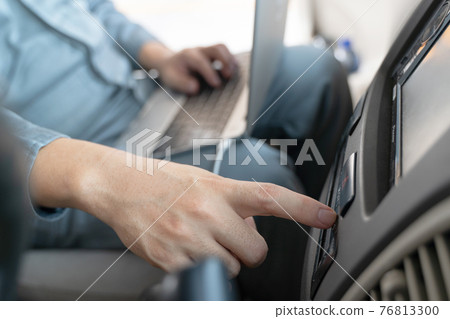 Mechanic using laptop computer to check during work a car engine on car at repair garage. focus finger hand Mechanic using laptop computer to check during work a car engine on car at repair garage. focus finger hand 76813300