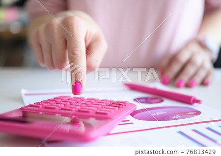 Female hands work calculator near pen and business charts 76813429