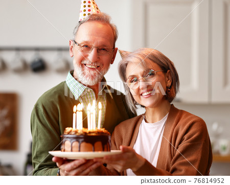 Elderly couple man and woman with cake celebrating birthday and anniversary 76814952