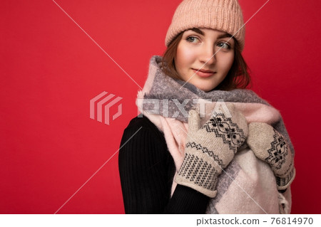 Closeup photo of beautiful happy cute young brunette woman isolated over red background wall wearing Closeup photo of beautiful happy cute young brunette woman isolated over red background wall wearing 76814970