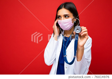 Photo of professional confident young european brunnet woman doctor in medical mask and white coat Photo of professional confident young european brunnet woman doctor in medical mask and white coat 76814976