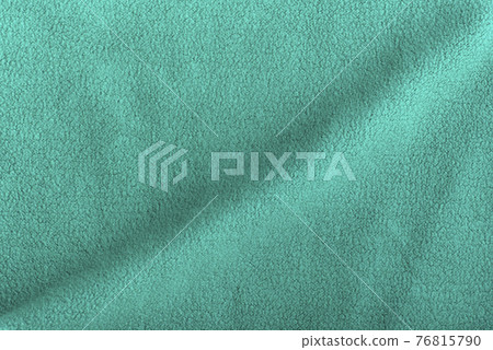 Green fleece background with wave. Surface of fabric, textile. Green fleece background with wave. Surface of fabric, textile. 76815790