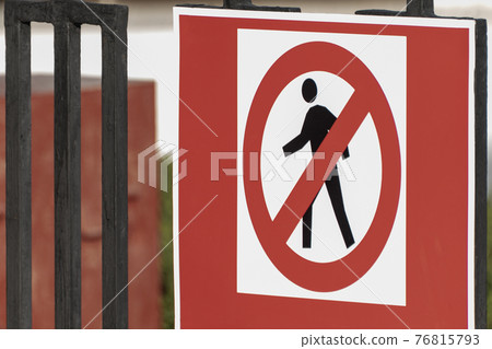 Traffic sign on the fence. No Pedestrians. No entry Traffic sign on the fence. No Pedestrians. No entry 76815793