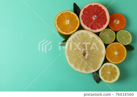 Ripe citrus on mint background, space for text Ripe citrus on mint background, space for text 76816560