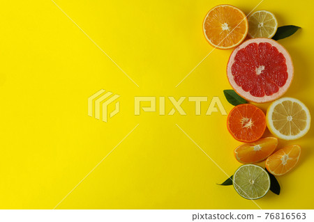Ripe citrus on yellow background, space for text Ripe citrus on yellow background, space for text 76816563