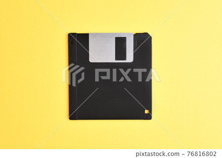 Floppy disk on yellow background Floppy disk on yellow background 76816802