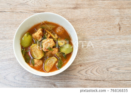 spicy boiled feather back fish ball with vegetable curry soup on bowl 76816835