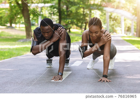 Black Athlete Couple Making One Hand Plank Exercise Together, Training Outdoors Black Athlete Couple Making One Hand Plank Exercise Together, Training Outdoors 76816965