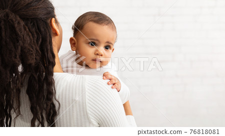 African American Mother Posing With Cute Baby Over Gray Wall 76818081