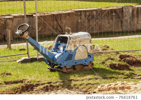 Vibratory plate compactor in construction site Vibratory plate compactor in construction site 76818761