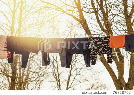 Rope with clean clothes outdoors on laundry day Rope with clean clothes outdoors on laundry day 76818762