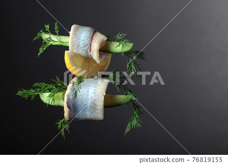 Herring fillet in oil with lemon, cucumber, and dill. 76819155