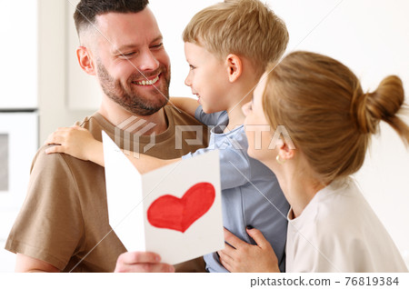 Little boy son congratulating daddy with Fathers day at home 76819384