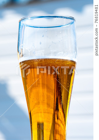 Light beer in a glass wine glass on a picnic on the nature 76819481